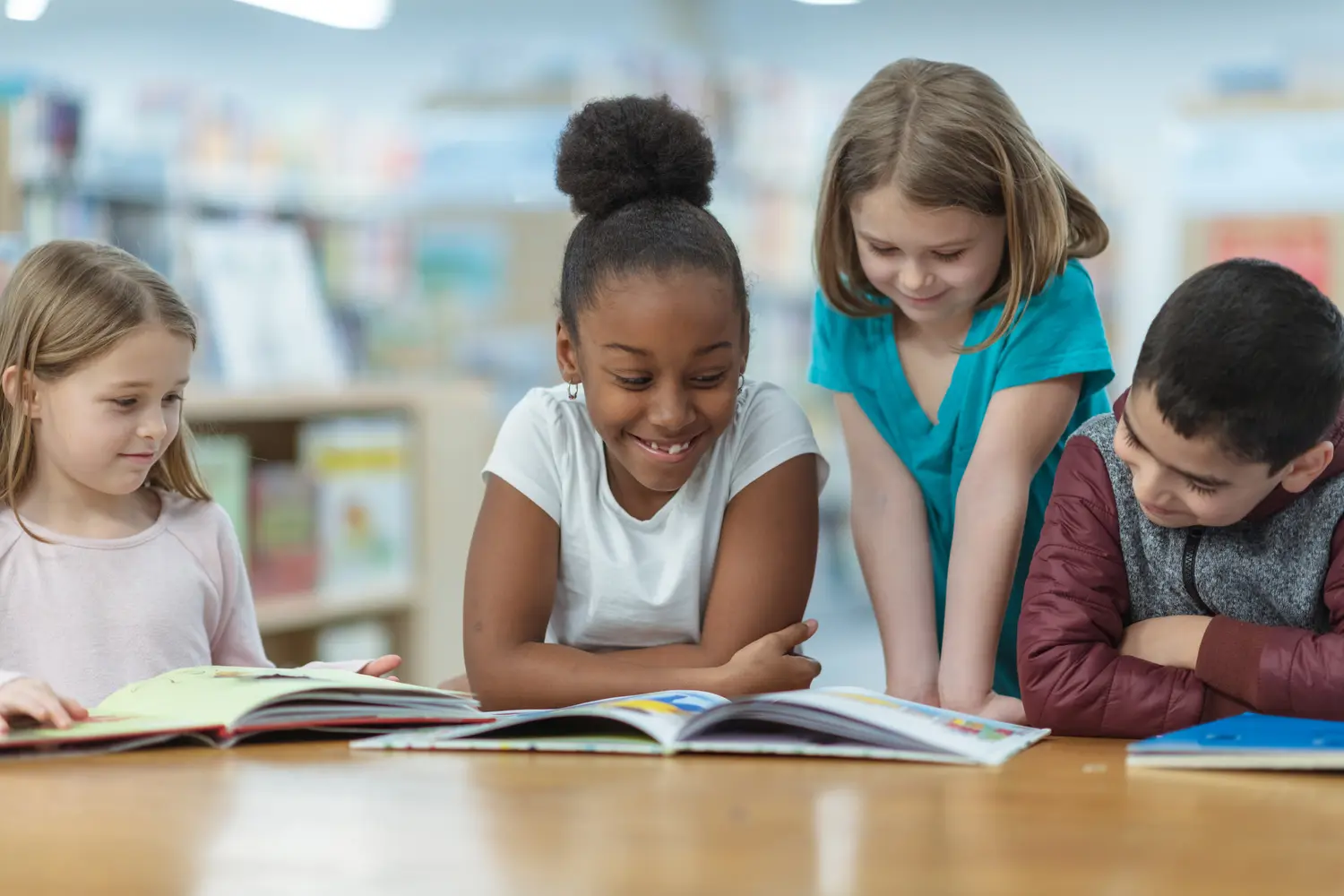 Elementary students reading together in a school library